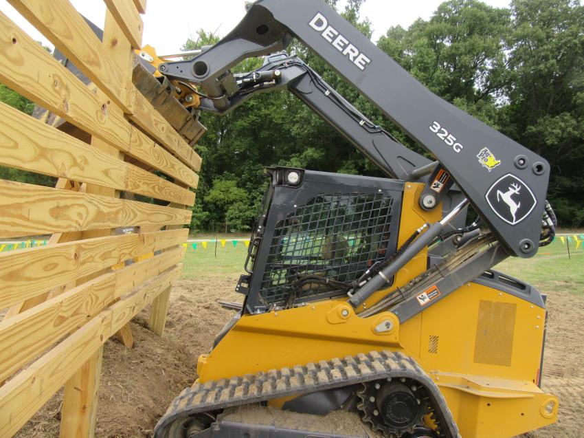 Eight-year-old Kingzton Watson demonstrates a great deal of experience and skill as an operator with this John Deere 325G compact track loader.
