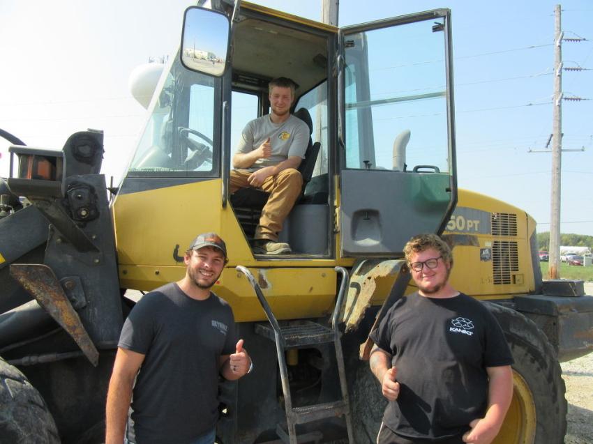 (L-R): After entering successful bids on a number of machines, KR Equipment’s Nick Gerthung, Rebel Mead and Charlie Utsinger reviewed this Komatsu WA250 wheel loader.