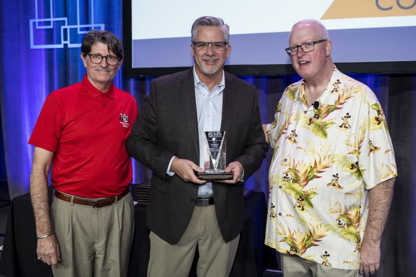 The Foundation Champion Award: (L-R) are Jeff Scott, AED Foundation chairman; Terry Dolan, Case Construction Equipment; and Brian McGuire, AED Foundation president.