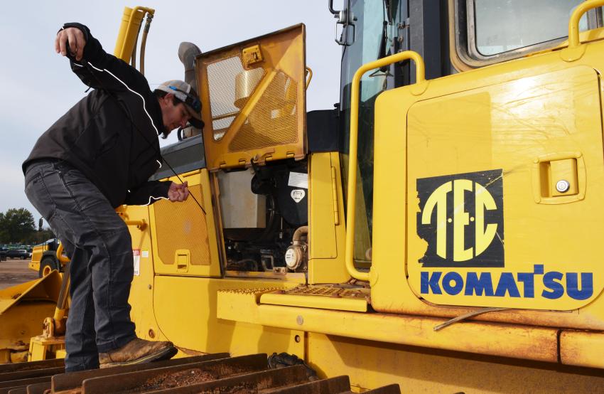 Checking the fluids and components during his machine inspection of a Komatsu D65PX dozer is Brett Childers of Jonathan Burns Construction, Columbus, Miss.  (CEG photo)