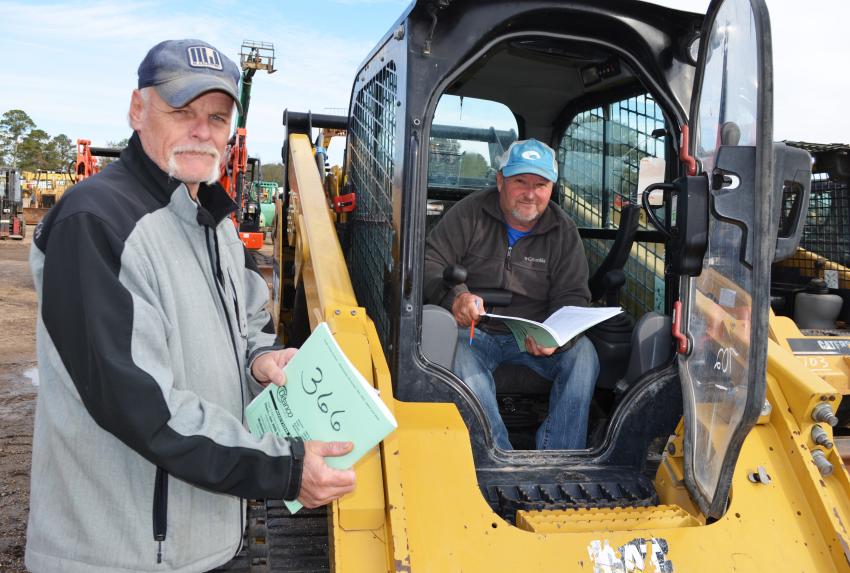 Reading up on some compact track loaders of interest are Edward Alleman (L), A’s Turtle Farm, Belzoni, Miss., and Mackie Breazeale, Riverside Lawn and Land Services, Bay St. Louis, Miss. (CEG photo)