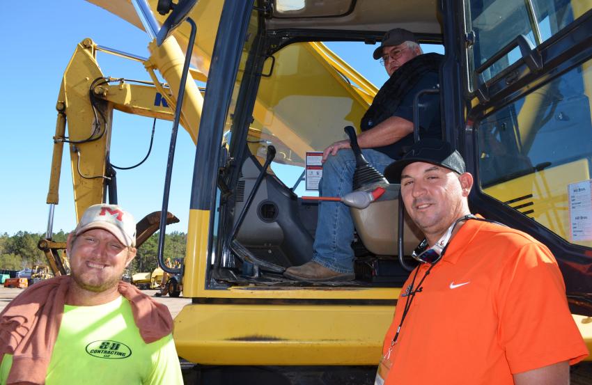 (L-R): Joel Esque, Russell Henley and Stacy Herron, all of S&B Contracting, Kiln, Miss., were quite interested in this Komatsu PC360 that was about to go on the auction block. (CEG photo)