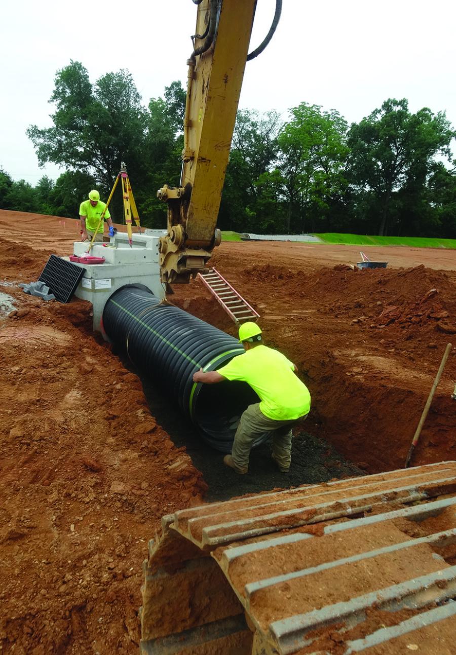 An SI pipe crew sets a segment of sewer pipe on the 35-acre Woodmont at Upper Macungie project, a residential development in Lehigh County.