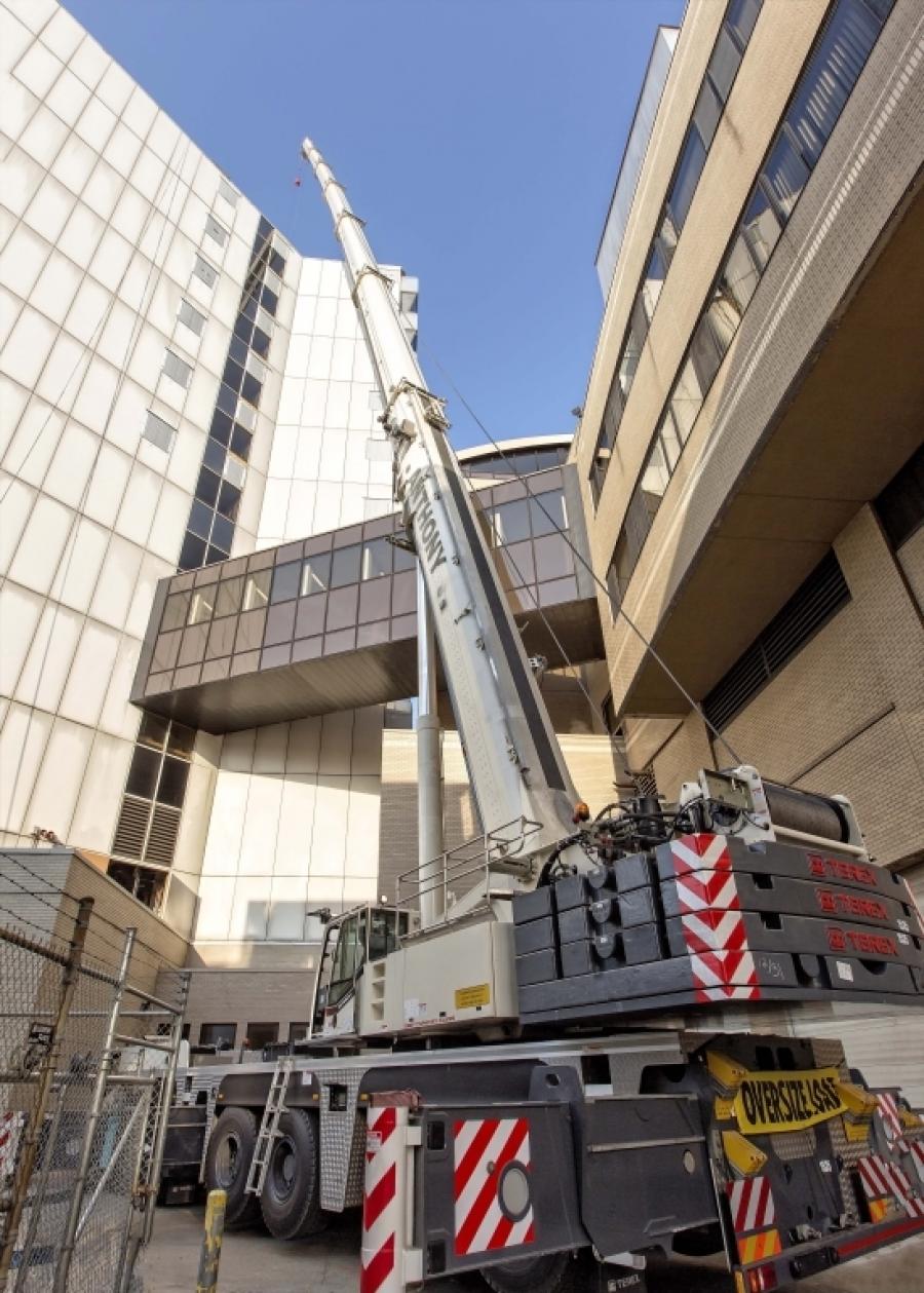 The crane was required to work at a radius that would allow the boom to raise straight up and over the building without hitting the skybridge to make the HVAC equipment lifts and load the old pieces onto trucks.