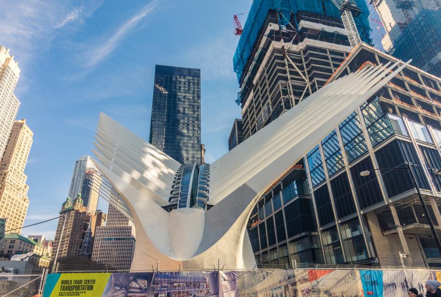 Image courtesy of JJBers via Wikipedia. The soaring, white transportation hub opening at the World Trade Center was designed to evoke a bird in flight, but it is hatching under a cloud.