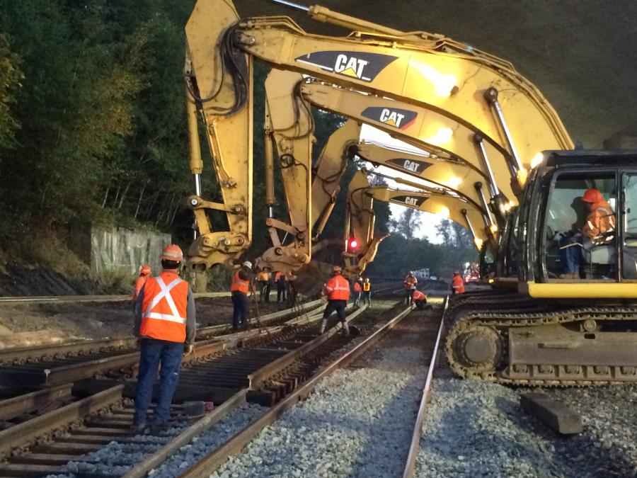Excavators lower part of a turnout track near Nisqually as part of the new route trains will use in and out of Tacoma.
