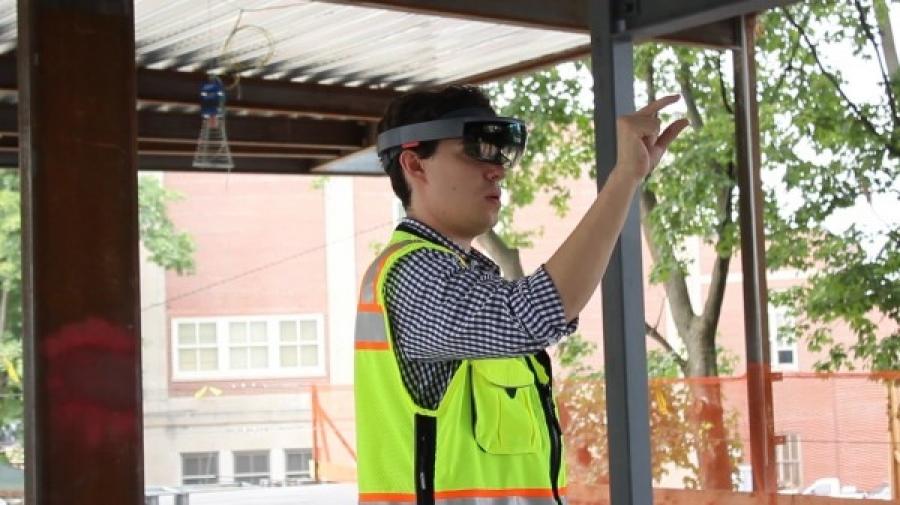 Gilbane’s John Myers uses HoloLens to review a virtual 3-D model of Boston’s Dearborn STEM Academy. (MIT Technology Review photo)