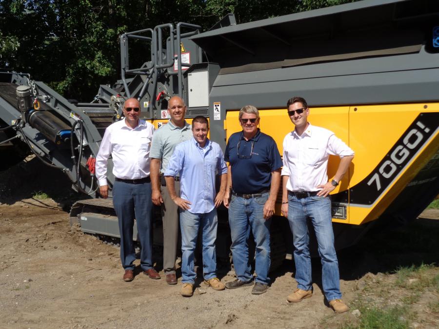 (L-R) are Gerald Hanisch, Steven Abbott, Brandon Lothrop, Tim Grip, René Wagner with the RM 70GO! compact crusher. This machine is a self-contained, tracked compact crusher designed to crush concrete, asphalt, C&D waste and rock. It can turn this material into a valuable building material with compaction in a single pass.