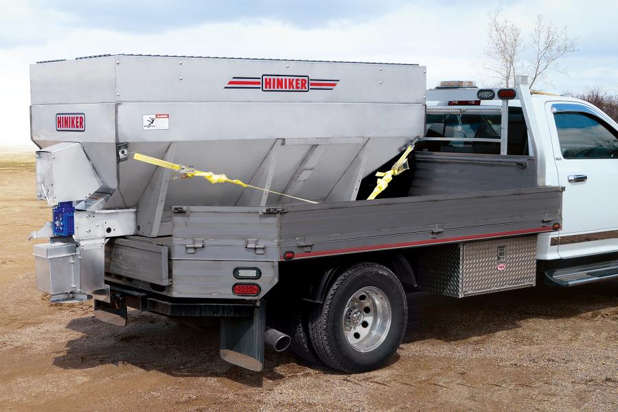 A convenient tip-up spinner assembly makes unloading unused material simple and provides easy trailer hitch access.