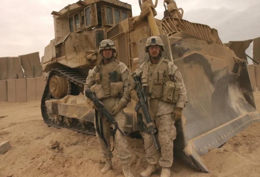 Photo courtesy of U.S. Marine Corps Sgt. Josh Hauser. Chief Warrant Officer 4 Alan J. Clyne, left and Master Sgt Scott E. Witmer stand in front of the Caterpillar D9 dozer they used to clear a path to safety to stranded Marines during Operation Steel Curtain.