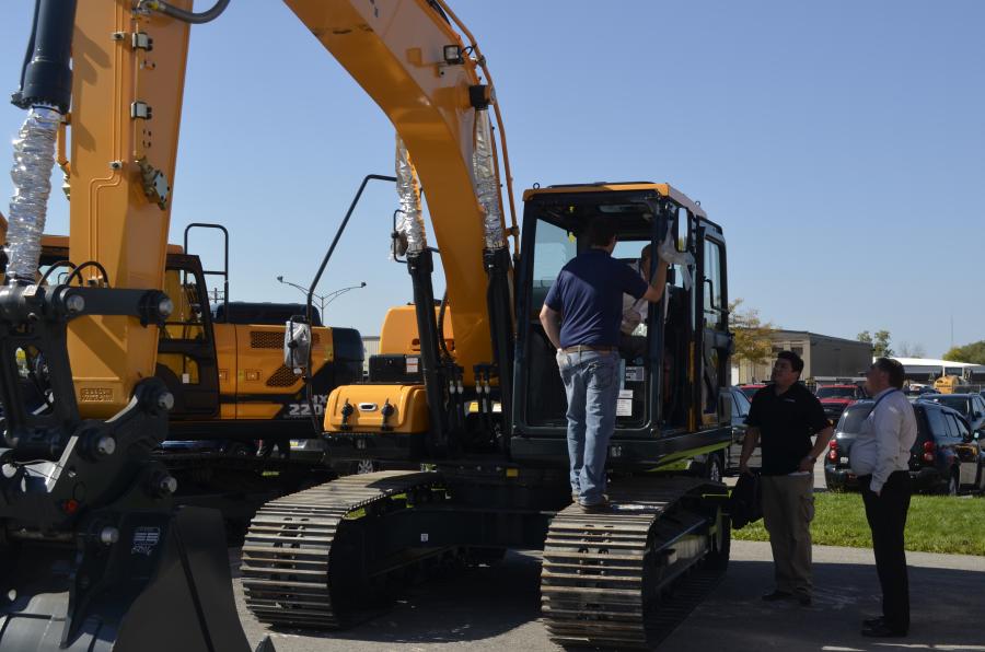 Interested buyers seek information on the Hyundai excavators from factory representatives.