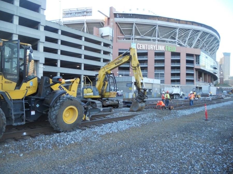 A Komatsu WA320 wheel loader (foreground) and a Kobelco 175 excavator are two of the workhorses involved in replacing hand-operated switches with automatic switches at King Street Station in Seattle. (WSDOT photo)