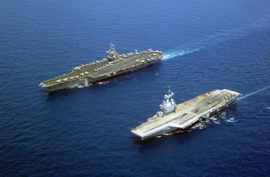 The U.S. Navy aircraft carrier USS Enterprise (CVN-65), the world's first nuclear-powered aircraft carrier, steams alongside the French aircraft carrier Charles De Gaulle (R 91). Enterprise and her battle group were on a scheduled deployment in the Mediterranean Sea.