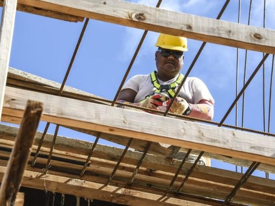 Carpenter Negs Barrozo prepares to fasten lumber together into a form, as he and other 5M Construction Corporation employees, work at a building project in Tamuning on Tuesday, Oct. 4. (Pacific Daily News photo)