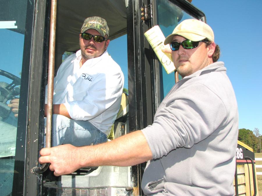 Tim Haley (L) of H&H Equipment, Haleyville, Ala., and  Jeremy Gibbs of Gibbs Farm & Timber, Brilliant, Ala., test out this Cat IT28G.