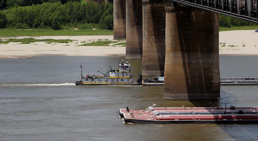 Two barges carefully pass each other on the Mississippi River.