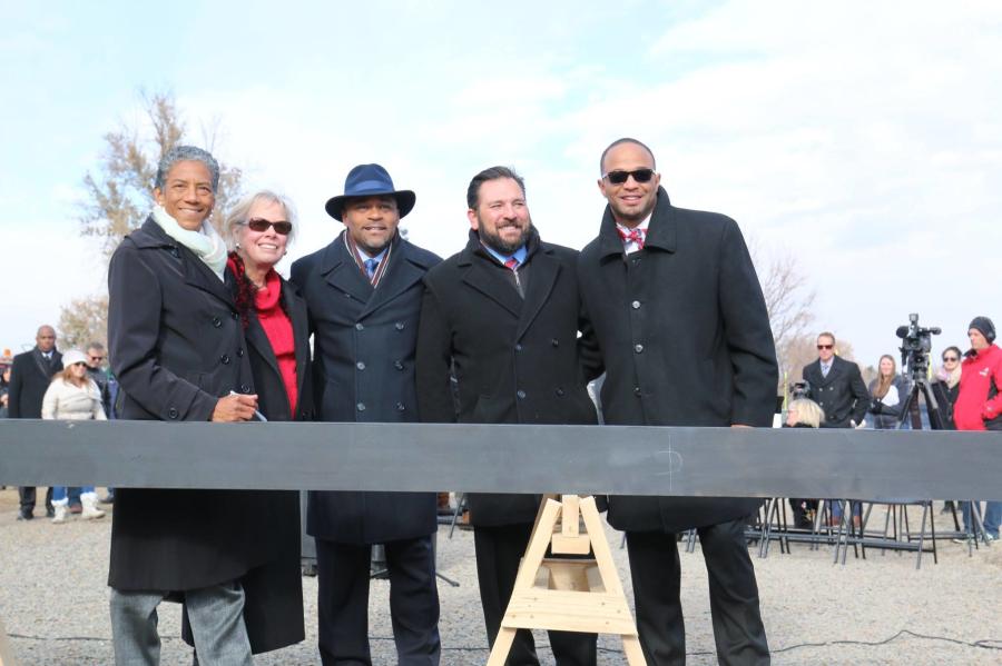 Denver Mayor Michael Hancock (C) and city officials, along with the construction and design team members, signed the ceremonial beam before it was placed on top of the structure being constructed.