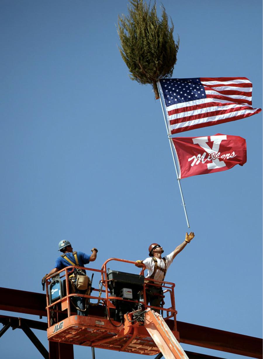 Aug. 31, 2010: Aaron East, left, and Dave Kaschmitter, ironworkers with All Steel, put up flags and a tree during a topping out ceremony at the new Yukon High School. [Photo by John Clanton, The Oklahoman Archives]