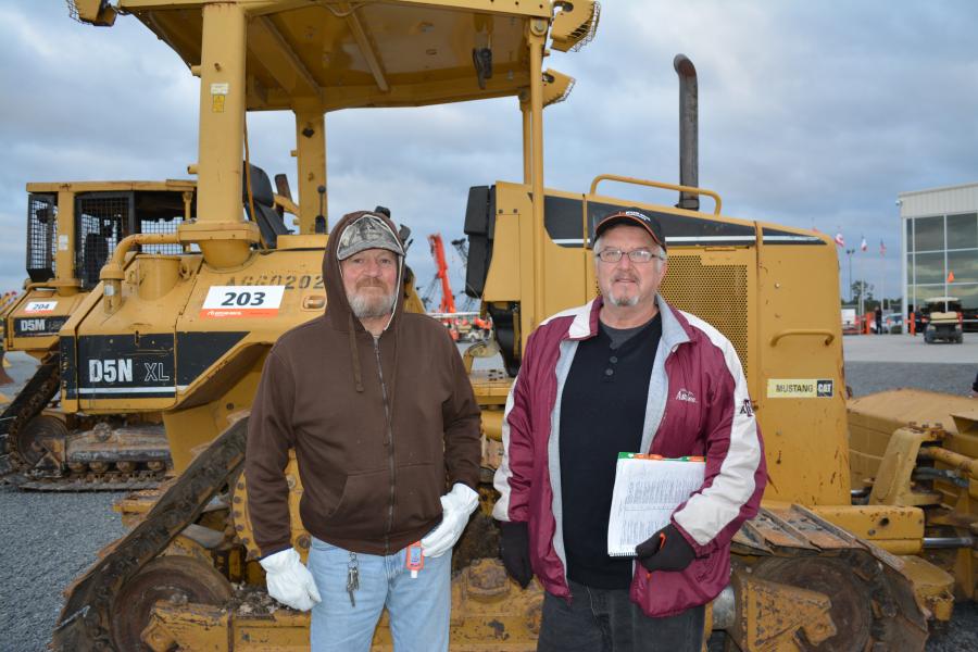 Billy Creek (L) and Gary Blackmor of Blackmor Land and Cattle, College Station, Texas, put the Cat D5N through its paces before bidding.