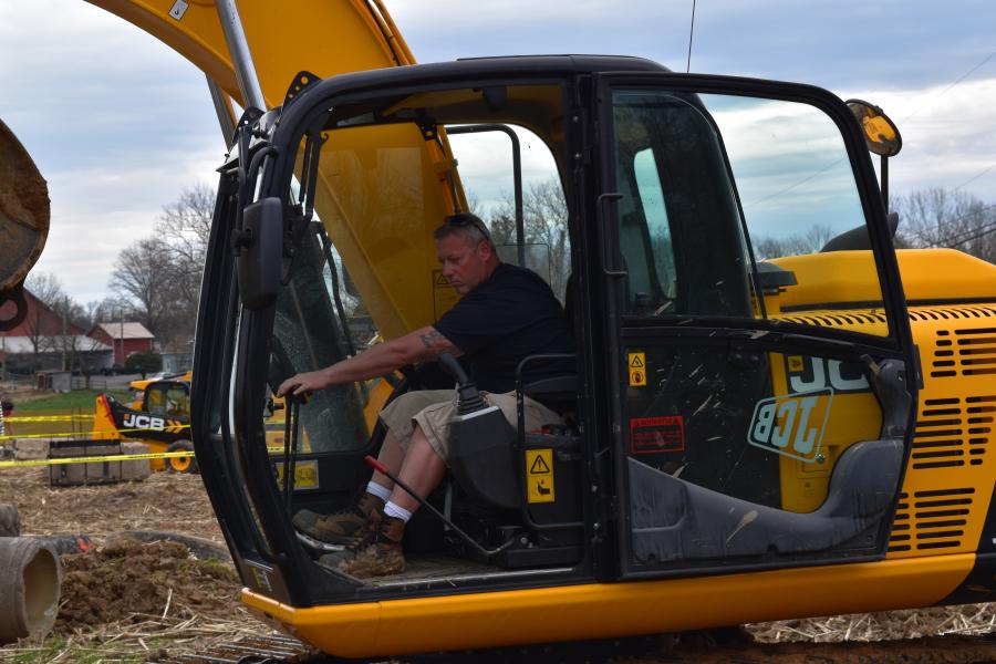 Darren Irvine, heavy equipment operator of Pennsbury School District, tries out this JCB excavator.