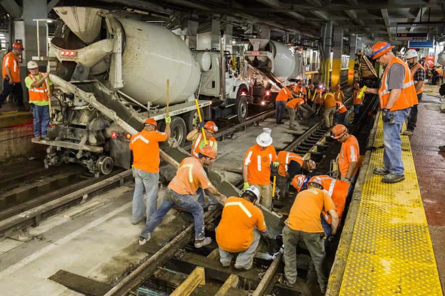 Amtrak photo
Amtrak crews pour concrete onto track 7 of New York Penn Station, in order to hold wooden ties in place that support rails that carry approximately 1,300 weekday train movements for three different railroads.
