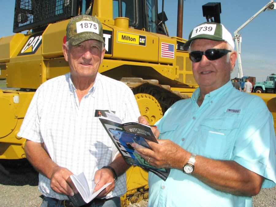 Dale Greer (L) of Columbia, Ky., and Jim Cassetty of Jim Cassetty Realtors, Hendersonville, Tenn., jot some notes on dozers of interest.
