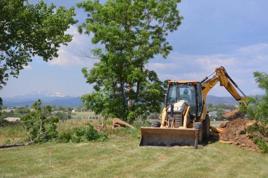 An operator from Zak Dirt Inc. uses a backhoe loader to dig a section of the new Colorado Front Range Trail-Loveland to Fort Collins Connection along Carpenter Road on June 22.
(Larimer County photo)