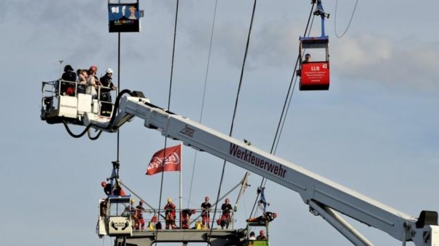 Crews used a mobile crane to bring the passengers to safety (Photo Credit: BBC).