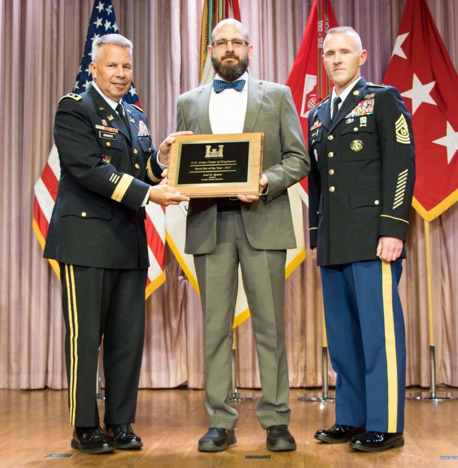 Joel Spano (C), lead quality assurance representative in the U.S. Army Corps of Engineers, Alaska District’s Area Office, receives the 2017 Chief of Engineers Hard Hat of the Year Award Aug.1 during a national ceremony in Washington, D.C. Lt. Gen. Todd Semonite (L), U.S. Army Chief of Engineers and commanding general of the U.S. Army Corps of Engineers, and Command Sgt. Maj. Bradley Houston presented the award.
