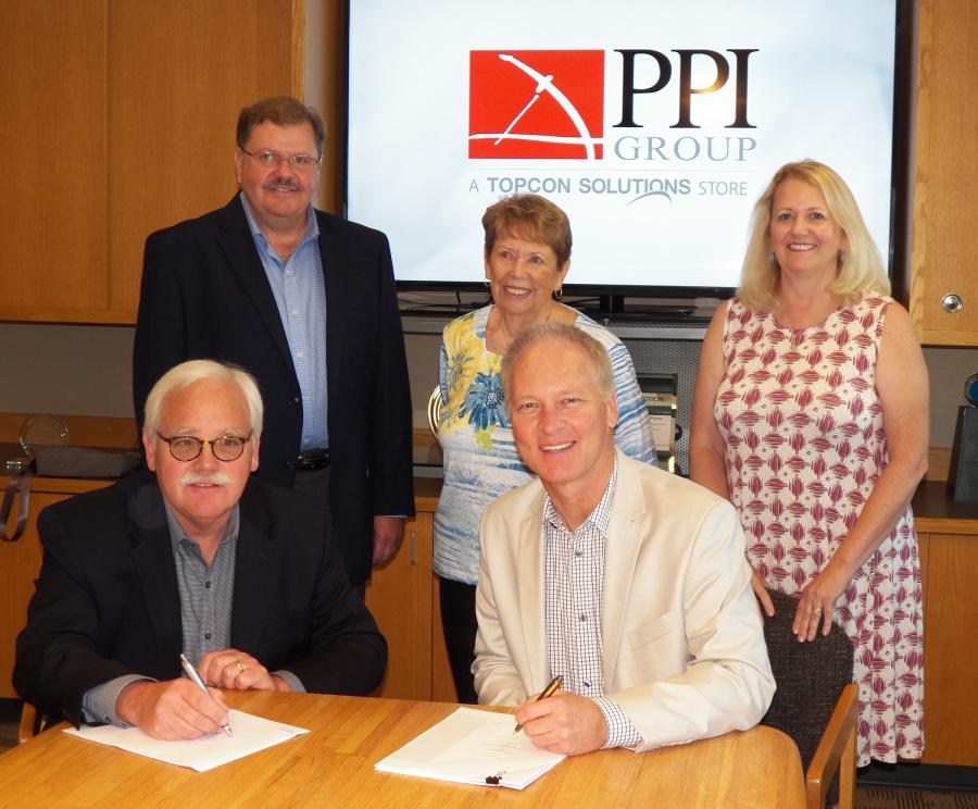 Jamie Williamson of Topcon with (clockwise from lower left) Tigue Howe, Jeff Peterson, Joan Peterson and Jean Howe of PPI Group during the signing event.