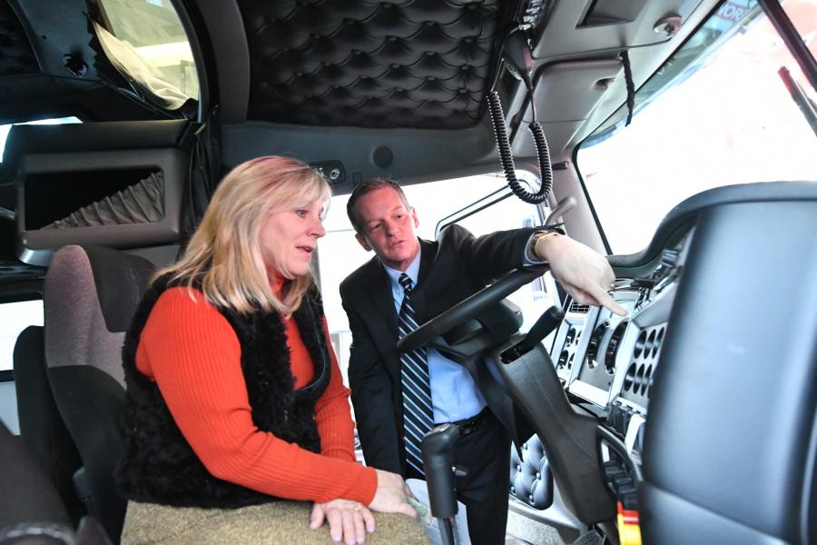 Kenworth Sales Company President Kyle Treadway (R) shows Salt Lake Community College President Deneece G. Huftalin a display in a Kenworth truck at the company's Salt Lake City area headquarters in West Valley City, Utah. Treadway recently announced he is donating $400,000 to the Westpointe Workforce Training & Education Center at the Salt Lake Community College.