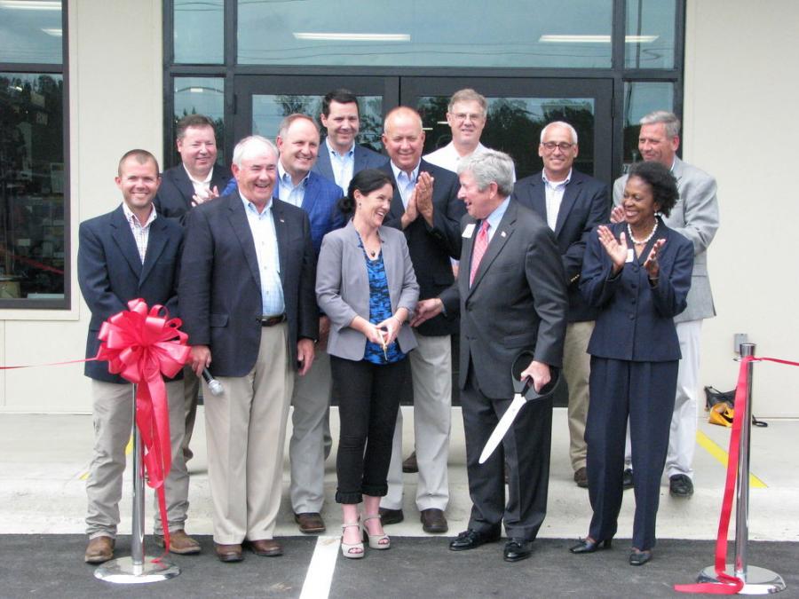Owners Mike Thompson and Lucy Thompson Marsh stand with Opelika, Ala., Mayor Gary Fuller at the center of the ribbon-cutting, flanked by other Thompson management personnel and other local dignitaries.