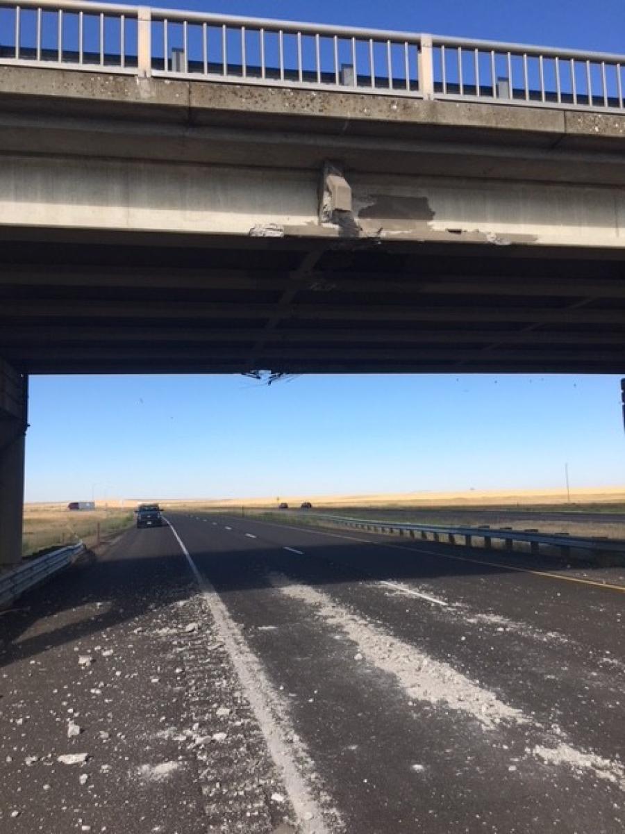A semi-truck transporting an excavator struck the bridge while traveling under it on eastbound I-90, damaging bridge girders and knocking loose concrete.
(WSDOT photo)