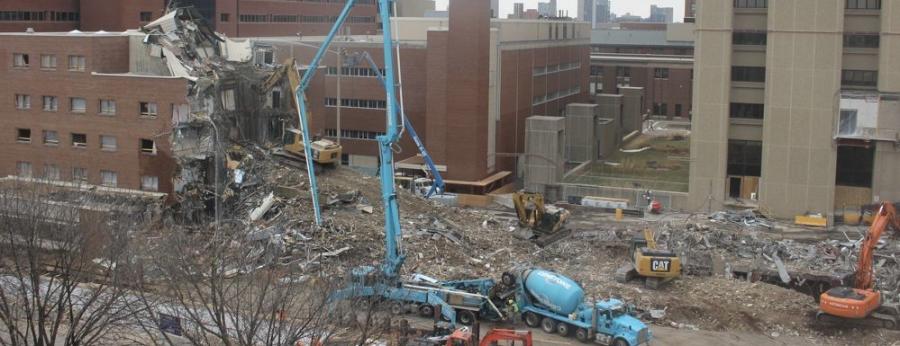 Excavators, off-road trucks and concrete-pump equipment have effortlessly joined the cranes and the crew in working on the foundations of the 22-story tower.
(University of Minnesota photo)