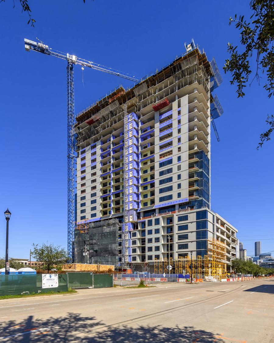 The new residential tower, which has topped out, overlooks downtown Houston and brings new retail and restaurants to the area. (Hoar Construction photo)