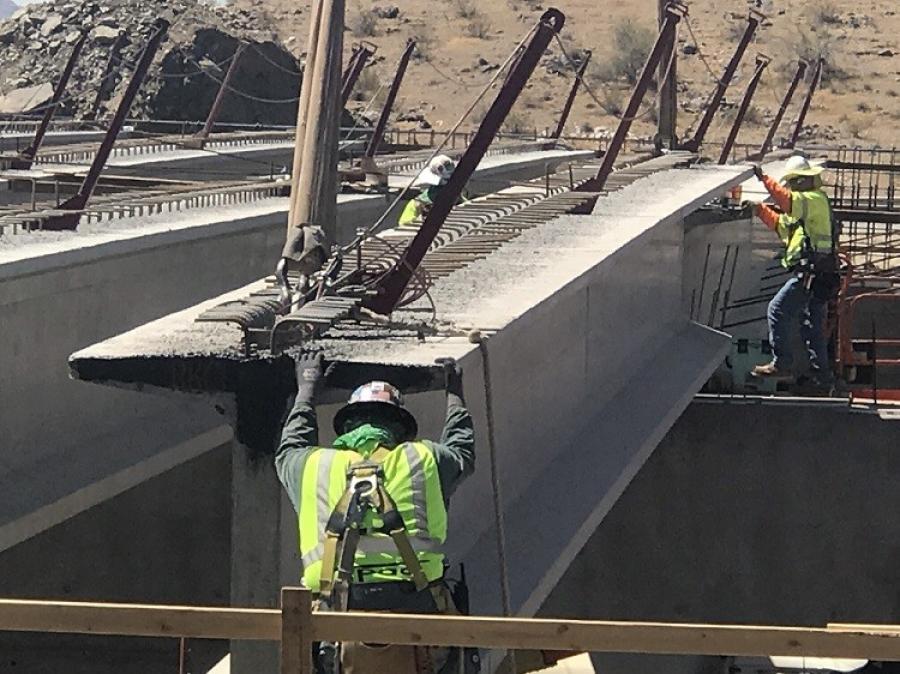 Crews with Connect 202 Partners, the freeway developer, lowered the 91-ft., 77,000-lb. girder into place recently at the interchange under construction at Desert Foothills Parkway in Ahwatukee.