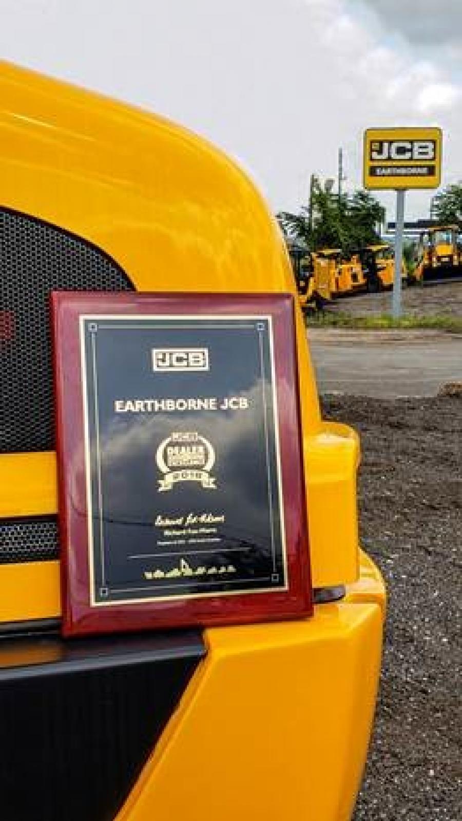 The Earthborne JCB Dealer of Excellence plaque, proudly propped on a JCB wheel loader.
