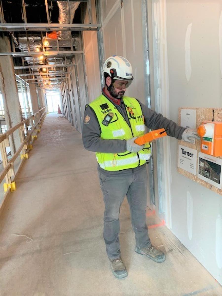 Project Safety Manager Kevin McDermott adjusts settings on the WES3 Fire and Emergency System at Turner Construction’s Hopper Hall project in Annapolis, Md.