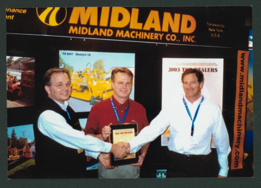 (L-R) Darrell Banks, Midland Machinery, presents a Top Ten Dealer award to Doug McLean and Bill McLean, both of McLean Company.