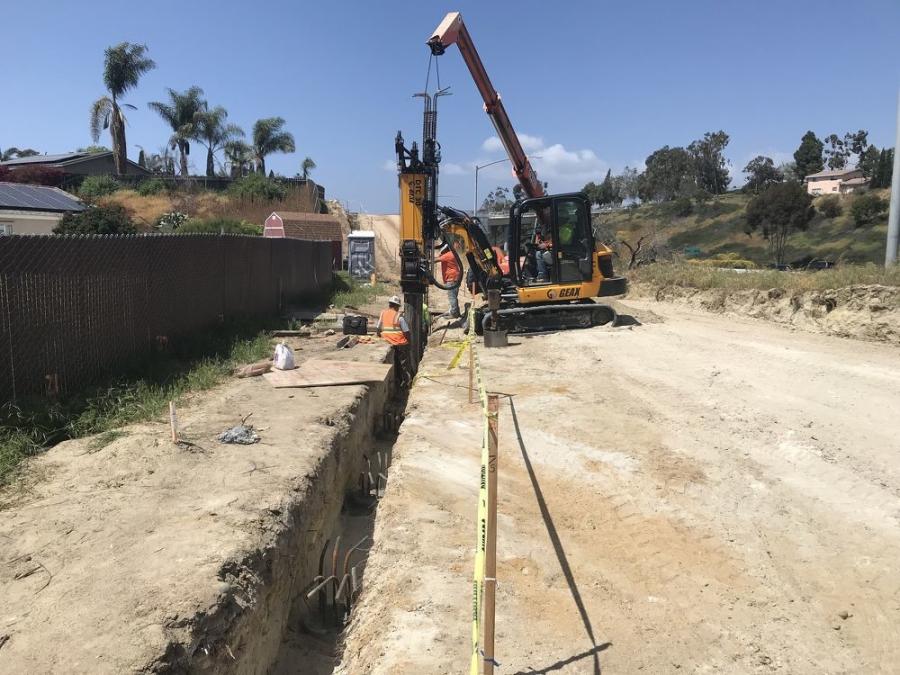 This photo demonstrates how close homes are located next to the highway. Here the cast and drill holes have been prepared and a concrete foundation will soon be installed. Nearly 70 percent of the sound walls have been erected.