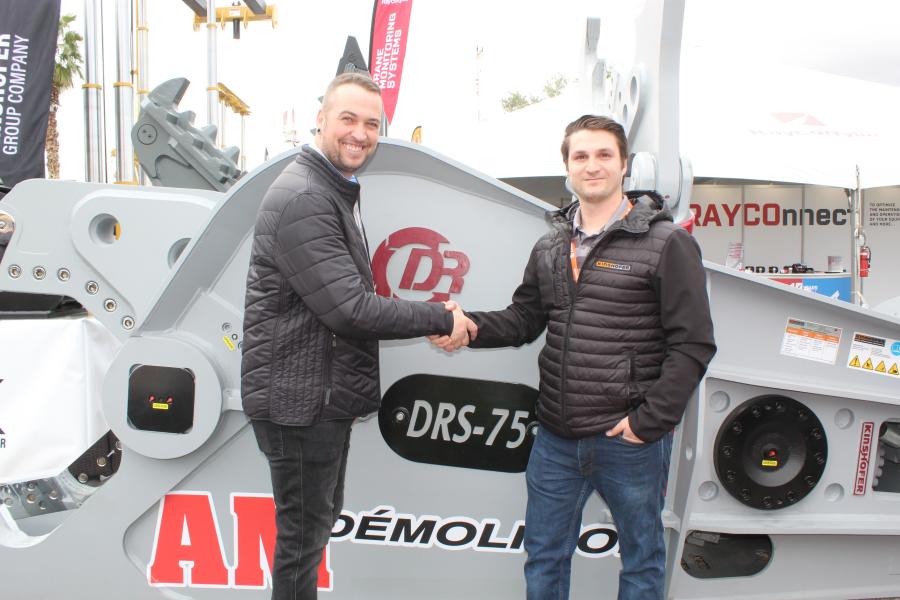Remi Maltais (L), president, AM Démolition, shakes hands with Jean-Nicolas Gonzalez, sales representative, Groupe Gymdex, in front of the Kinshofer DSR-75-A mobile scrap shear.