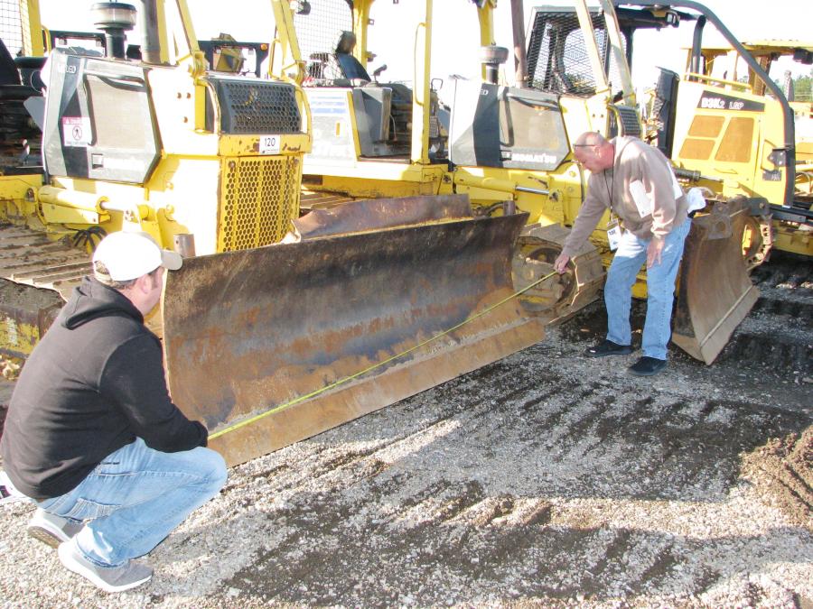 Measuring out the blade of a Komatsu D31PX dozer of interest are Cody Cutrer (L) and Roland Cutrer of RLC Construction, New Orleans, La.