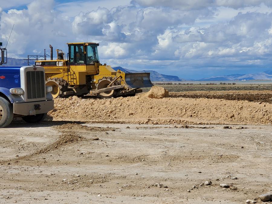 A Cat 825 compactor performs work on the job site for a project that includes one new bridge over I-80 and an interchange for traffic to get on in east and westbound directions. There is also one cattle crossing for a local landowner.