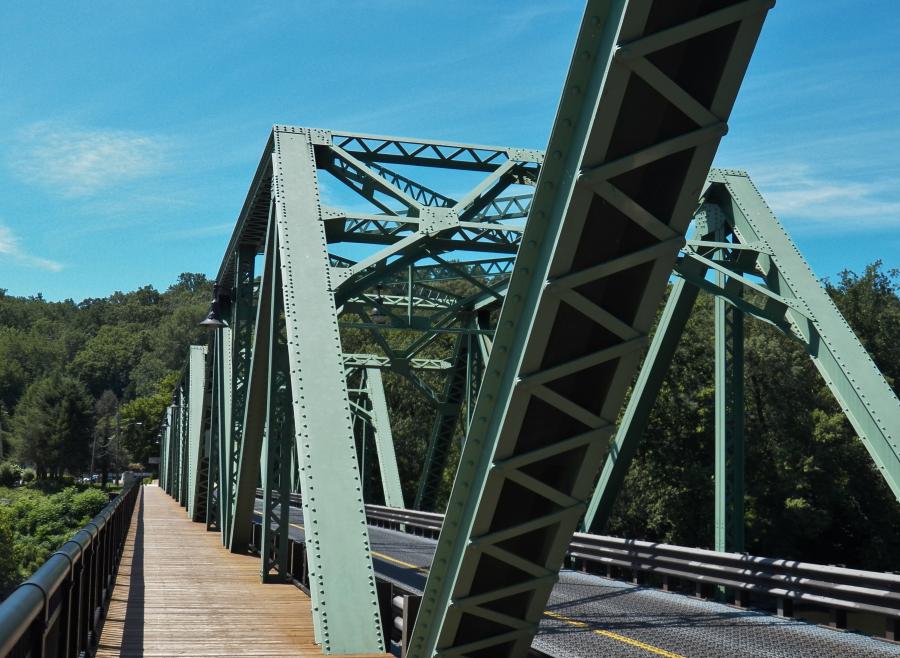 The existing bridge, opened to traffic in 1927, is a six-span, riveted steel Warren truss structure with a total length of 825 ft.