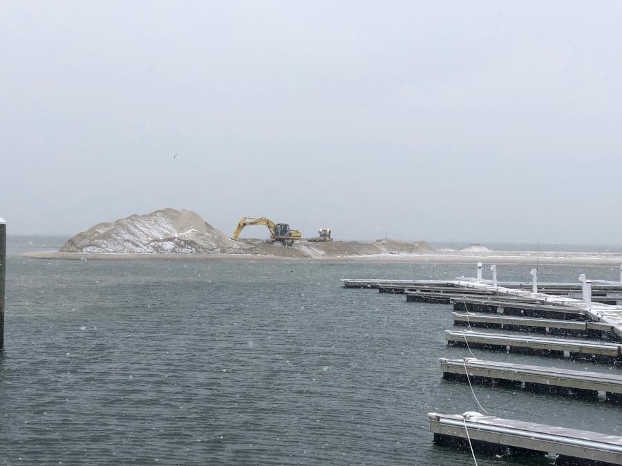 The dredging, which removed and relocated some 30,000 cu. yds. of sand, unearthed old mooring anchors and chains, which are being cleaned up and will be re-used.