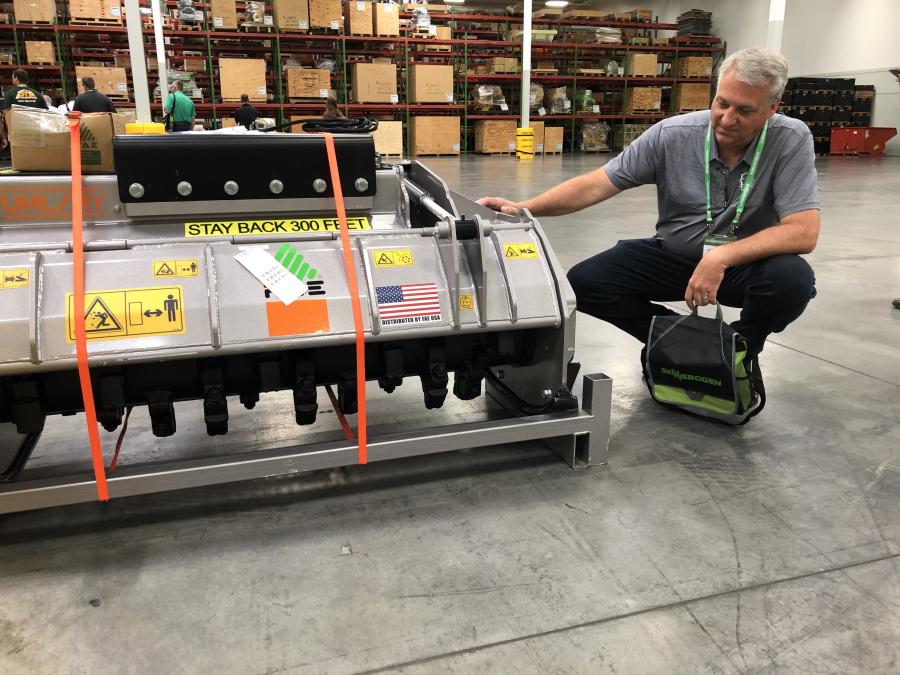 Sennebogen works with many different attachment manufacturers on installation procedures to make sure both companies products perform as expected.  Wade Myers of Wright Tree Service in Des Moines, Iowa, looks over the FAE UML/HY excavator mulcher.
