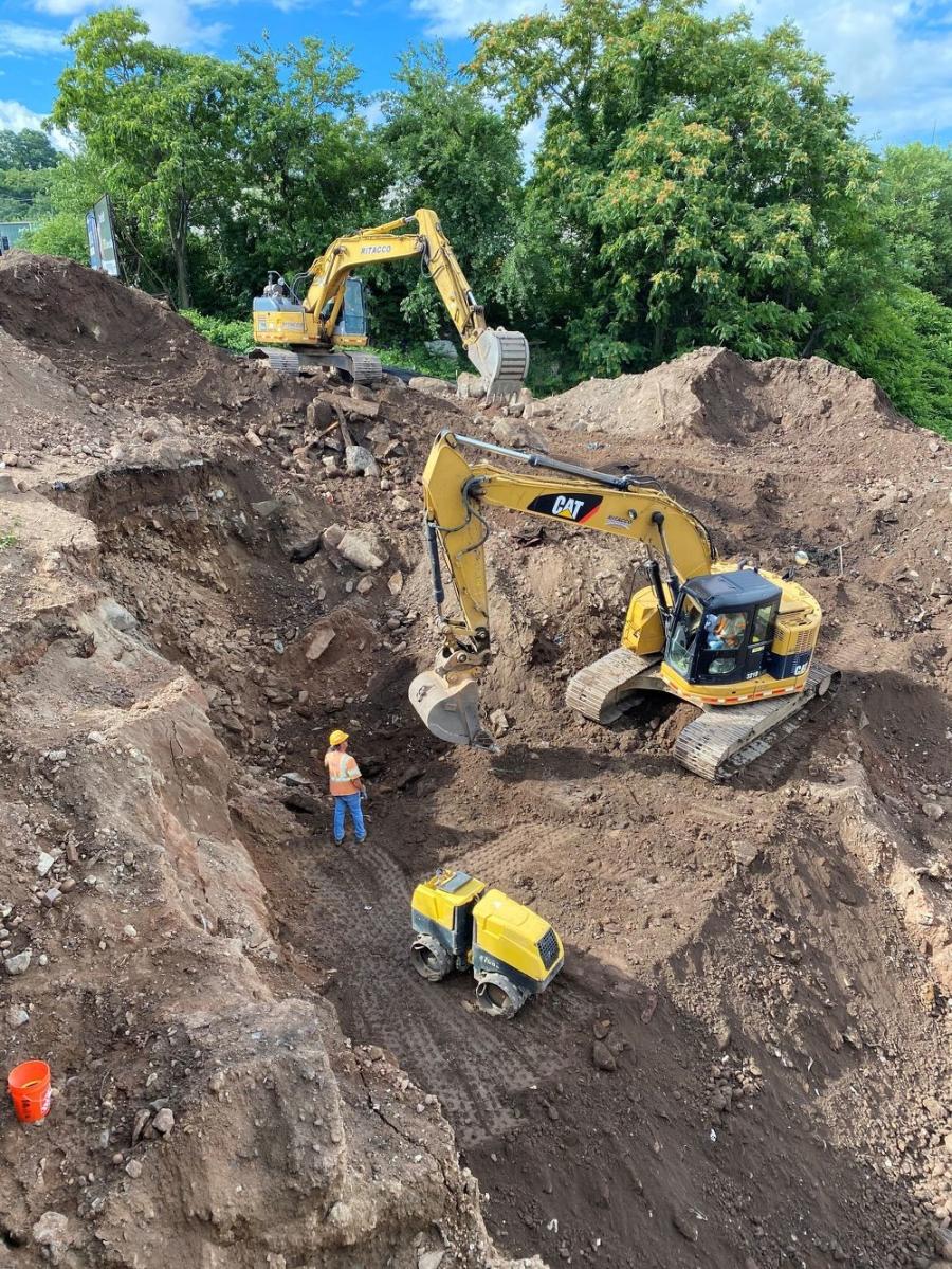 Crews excavate large boulder obstructions prior to installation of wick drains for the new foundation of abutment and retaining walls on the southeast corner of the new bridge.