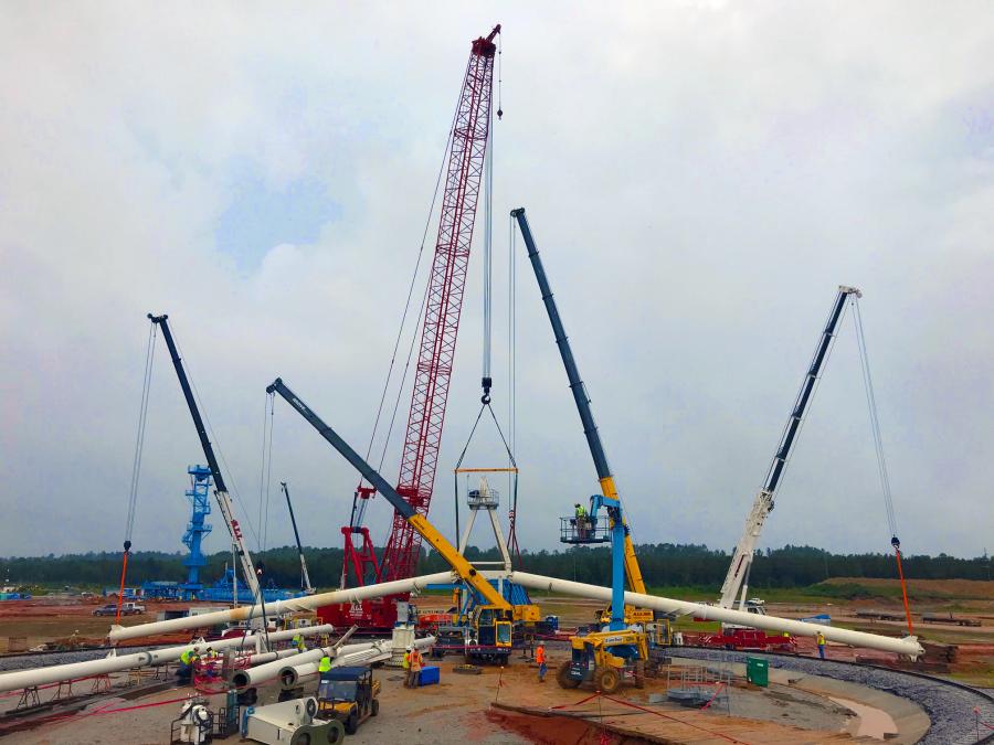 To lift the lumberyard crane, these five cranes were arranged roughly in a circle. The Manitowoc 2250 and Grove GMK6300L-1 connected to opposite ends of the workpiece jib, the Liebherr LTM 1090-4.2 controlled the left leg, and the Link-Belt HTC-8675 Series II controlled the right leg. The Grove TMS500-2 lifted the horizontal brace that had to be secured between the two legs after placement.