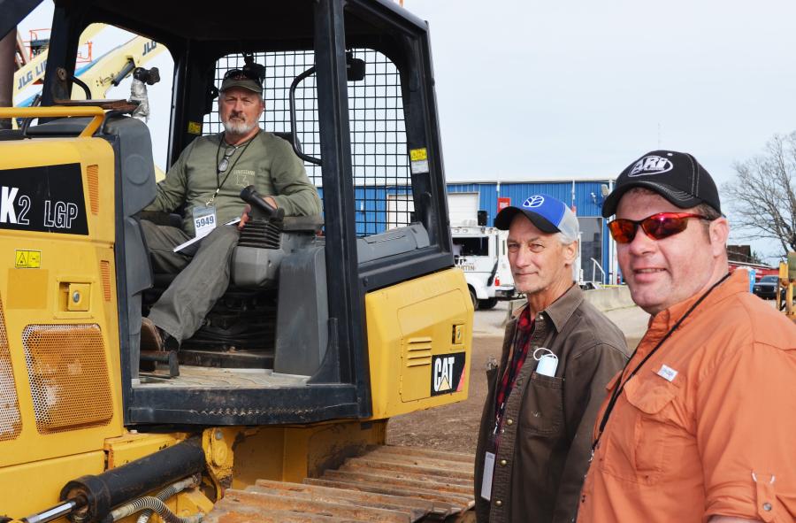 Discussing their thoughts of this Cat D4J2 (L-R) are Kim Ducote, C & K Transportation, Folsom, La.; Greg Williams, Williams Dozer Service, Neely, Miss.; and Troy Nicholson, an independent contractor based in Franklinton, La.