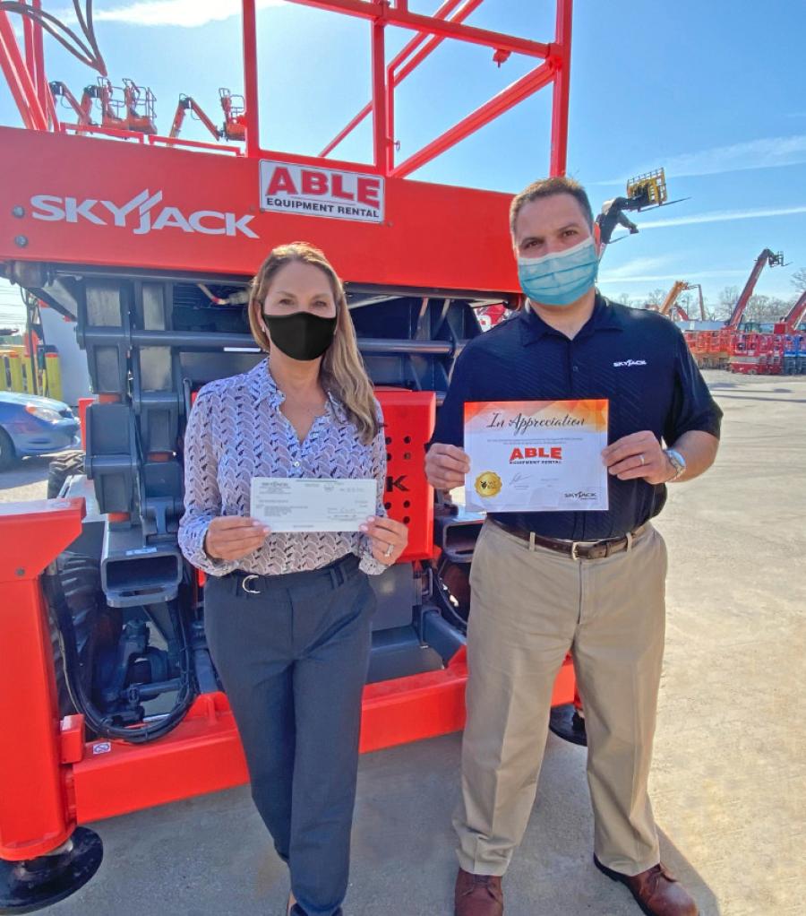 Eliza Laganas, ABLE Equipment Rental’s general counsel, accepts a check for $1,000 and a Certificate of Appreciation from Joe Guerino, Skyjack’s territory sales manager. 